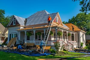 contractors replacing an old home's roof